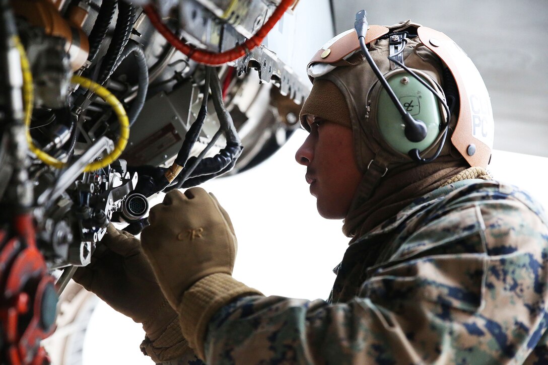 Marine Corps Sgt. Avelinobong Quero works on an F/A-18D Hornet aircraft on Chitose Air Base in Hokkaido, Japan, Jan. 13, 2016. Quero is a fixed-wing aircraft mechanic assigned to Marine All Weather Fighter Attack Squadron 224. U.S. Marine Corps photo by Cpl. Jessica Quezada