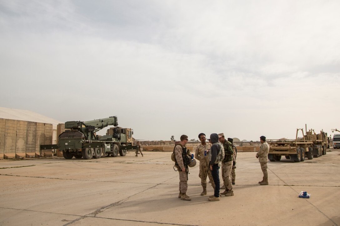 U.S. Marines with Special Purpose Marine Air-Ground Task Force-Crisis Response-Central Command assist Iraqi soldiers from the 8th Iraqi Army transport Alaskan barriers at Al Taqaddum Air Base, Iraq Jan. 8, 2016. The 12-ton barriers are placed around structures to reinforce them and provide protection from shrapnel. Advise and assist sites, like Al Taqqadum Air Base, are an integral part of Combined Joint Task Force – Operation Inherent Resolve’s multinational effort to increase the military capacity of Iraqi Security Force personnel to defeat the Islamic State of Iraq and the Levant. (U.S. Marine Corps photo by Cpl. Akeel Austin/Released)