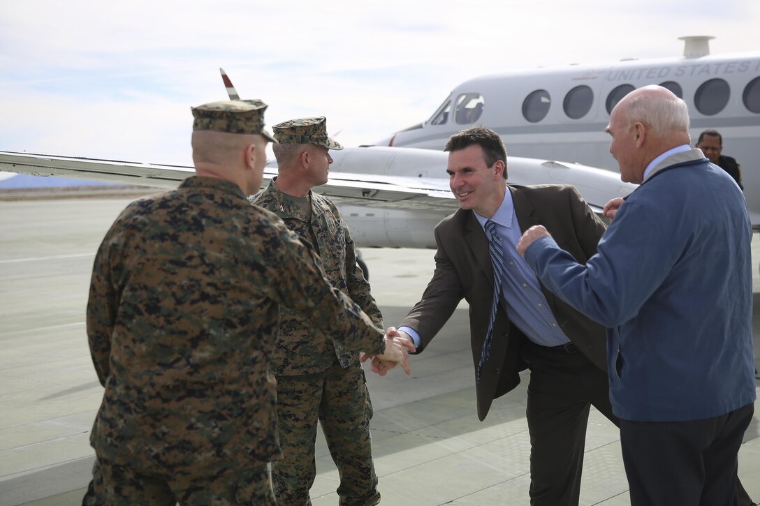 Col. Jay Wylie, assistant chief of staff, G-4 Installations and Logistics, and Maj Gen. Lewis A. Craparotta, Combat Center Commanding General, greet Mr. Joseph Bryan, Deputy Assistant Secretary of the Navy, and the Honorable Dennis V. McGinn, Assistant Secretary of the Navy at the Strategic Expeditionary Landing Field, Jan. 21, 2016. McGinn later awarded the Combat Center’s Exercise Support Division the 2015 Secretary of the Navy Energy and Water Management Award in the United States Marine Corps Expeditionary category, at Lance Cpl. Torrey L. Gray Field. McGinn also recognized the Combat Center as an installation, for a Gold Level of Achievement under the awards program, which indicates a very good to outstanding energy or water program. (Official Marine Corps photo by Cpl. Medina Ayala-Lo/Released)