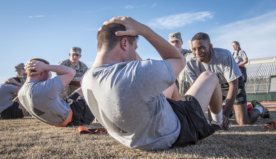 Army ROTC cadet Jean-Luc Sambira, right, holds the feet of cadet Evan Murphy during the sit-up portion of an Army Physical Fitness Test at Clemson University, S.C., Jan. 14, 2016. U.S. Army photo by Staff Sgt. Ken Scar  