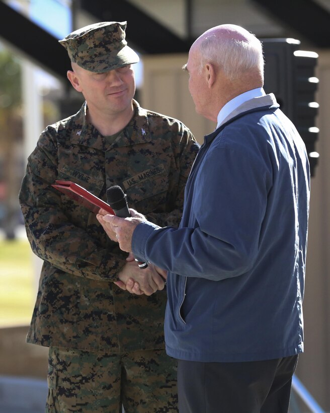 The Honorable Dennis V. McGinn, Assistant Secretary of the Navy, presents the Combat Center’s recognition for a Gold Level of Achievement, under the 2015 Secretary of the Navy Energy and Water Management Awards Program, to Col. Jay Wylie, assistant chief of staff, G-4 Installations and Logistics, at Lance Cpl. Torrey L. Gray Field, Jan. 21, 2016. The award recognizes the Combat Center as an installation for maintaining a very good to outstanding energy or water program.  (Official Marine Corps photo by Cpl. Medina Ayala-Lo/Released)
