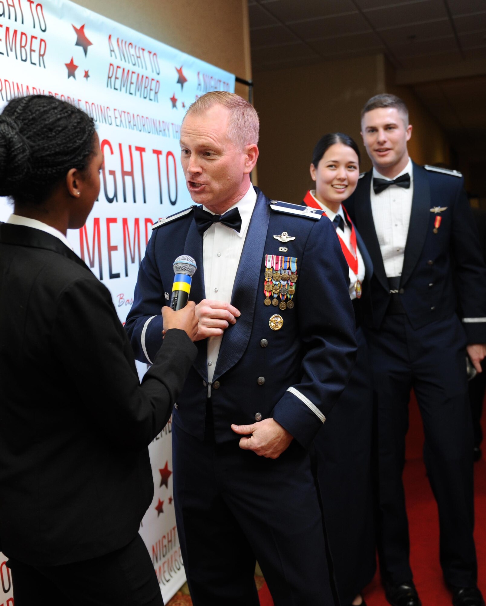 Col. Dennis Scarborough, 81st Training Wing vice commander, is interviewed on the “red carpet” by Airman 1st Class Adrienne Gordon, 81st Dental Squadron lab technician, during the 2015 Keesler Annual Awards Banquet at the Bay Breeze Event Center Jan. 20, 2016, Keesler Air Force Base, Miss. The ceremony recognized outstanding Airmen and civilians in 14 categories. The theme for the event was “ordinary people doing extraordinary things.” (U.S. Air Force photo by Kemberly Groue)