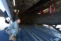 Army Spc. Mohamed Bouteldja, from the 25th Combat Aviation Brigade Schofield Barracks, and Air Force Staff Sgt. Alicin Muro, a loadmaster from the 535th Airlift Squadron, assist with the loading of a UH-60 Black Hawk, from the 25th CAB, into a C-17 Globemaster III, from the 535th AS, on Joint Base Pearl Harbor-Hickam, Hawaii, Jan. 21, 2016. Three UH-60 were loaded on to the C-17 as part of recurring training between the Air Force and Army. (U.S. Air Force photo by Tech. Sgt. Aaron Oelrich/Released)