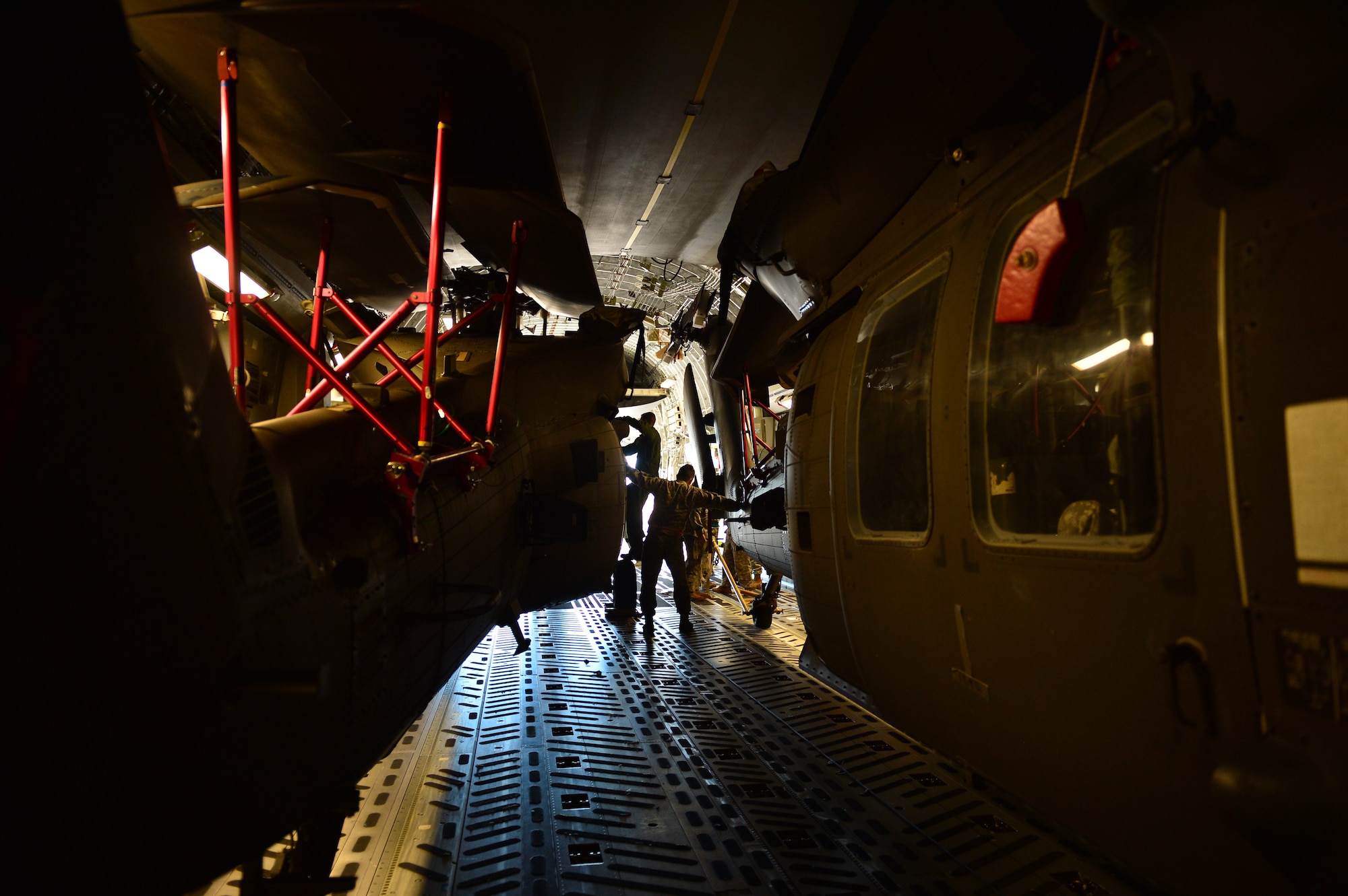 Soldiers, from 25th  Combat Aviation Brigade Schofield Barracks, assist with the loading of a UH-60 Black Hawk, from the 25th CAB, into a C-17 Globemaster III, from the 535th Airlift Squadron, on Joint Base Pearl Harbor-Hickam, Hawaii, Jan. 21, 2016. Three UH-60 were loaded on to the C-17 as part of recurring training between the Air Force and Army. (U.S. Air Force photo by Tech. Sgt. Aaron Oelrich/Released)