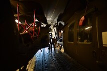 Soldiers, from 25th  Combat Aviation Brigade Schofield Barracks, assist with the loading of a UH-60 Black Hawk, from the 25th CAB, into a C-17 Globemaster III, from the 535th Airlift Squadron, on Joint Base Pearl Harbor-Hickam, Hawaii, Jan. 21, 2016. Three UH-60 were loaded on to the C-17 as part of recurring training between the Air Force and Army. (U.S. Air Force photo by Tech. Sgt. Aaron Oelrich/Released)