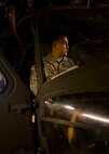 Army Sgt. 1st Class Jose Madrid, from the 25th Combat Aviation Brigade Schofield Barracks, holds the brakes on a UH-60 Black Hawk that was loaded into a C-17 Globemaster III, from the 535th Airlift Squadron, on Joint Base Pearl Harbor-Hickam, Hawaii, Jan. 21, 2016. Three UH-60 were loaded on to the C-17 as part of recurring training between the Air Force and Army. (U.S. Air Force photo by Tech. Sgt. Aaron Oelrich/Released)