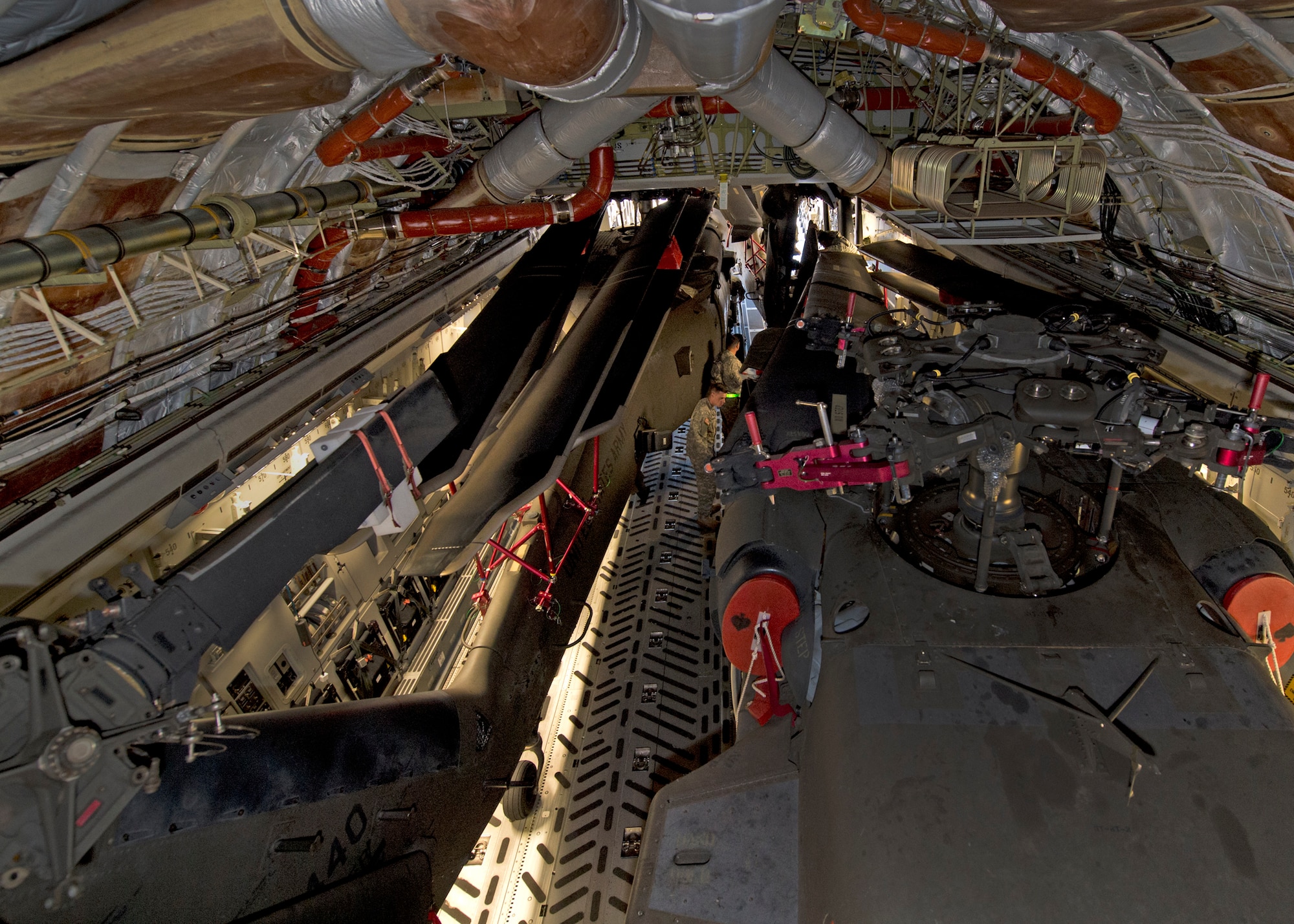 Airmen from the 535th Airlift Squadron and Soldiers, from 25th Combat Aviation Brigade Schofield Barracks, worked together to load three UH-60 Black Hawk into a C-17 Globemaster III, from the 535th AS, on Joint Base Pearl Harbor-Hickam, Hawaii, Jan. 21, 2016. The UH-60 were loaded on to the C-17 as part of recurring training between the Air Force and Army. (U.S. Air Force photo by Tech. Sgt. Aaron Oelrich/Released)