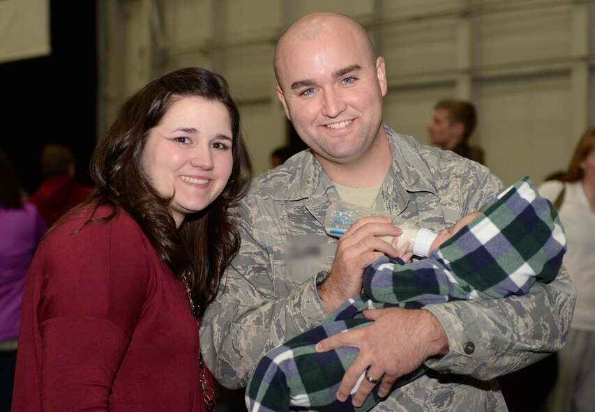 Staff Sgt. Justin, 28th Munitions Squadron munitions system controller, reunites with his wife, Blair, and his son, William, at Ellsworth Air Force Base, S.D., Jan. 24, 2016. Approximately 350 Airmen returned from a deployment to Southwest Asia where they delivered critical air presence, precision strikes, surveillance, and reconnaissance capabilities to support the objective in the region. (U.S. Air Force photo by Airman Donald C. Knechtel/Released)

