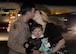 Capt. Cameron, 28th Aircraft Maintenance Squadron pilot, kisses his wife, Jessie, in front of aircraft Atlas after returning from a deployment to Southwest Asia at Ellsworth Air Force Base, S.D., Jan. 24, 2016. During the rotation, Ellsworth Airmen provided operational support to the 379th Air Expeditionary Wing 