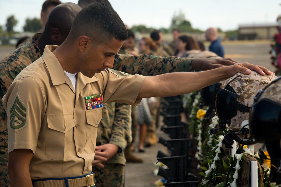 Marines, Sailors, Coast Guardsmen and family members pay their respects during a memorial ceremony honoring 12 Marines from Marine Heavy Helicopter Squadron 463 aboard Marine Corps Air Station Kaneohe Bay, Jan. 22, 2016. Two CH-53E Super Stallion helicopters with HMH-463 were involved in an incident off the coast of North Shore, Oahu, Hawaii, Jan. 14. 
