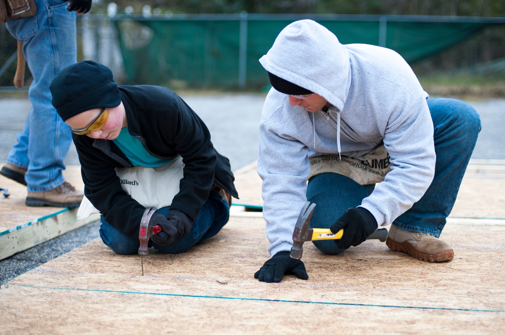U.S. Air Force Tech. Sgt. Brian Marshall, 823d Base Defense Squadron squad lead, right, and his son, Carter Marshall, work together to build a wall during a Habitat for Humanity volunteer event, Jan. 23, 2016, in Valdosta, Ga. Habitat for Humanity works with the help of many volunteers from the local community to build houses for qualified families. (U.S. Air Force photo by Airman 1st Class Lauren M. Johnson/Released)