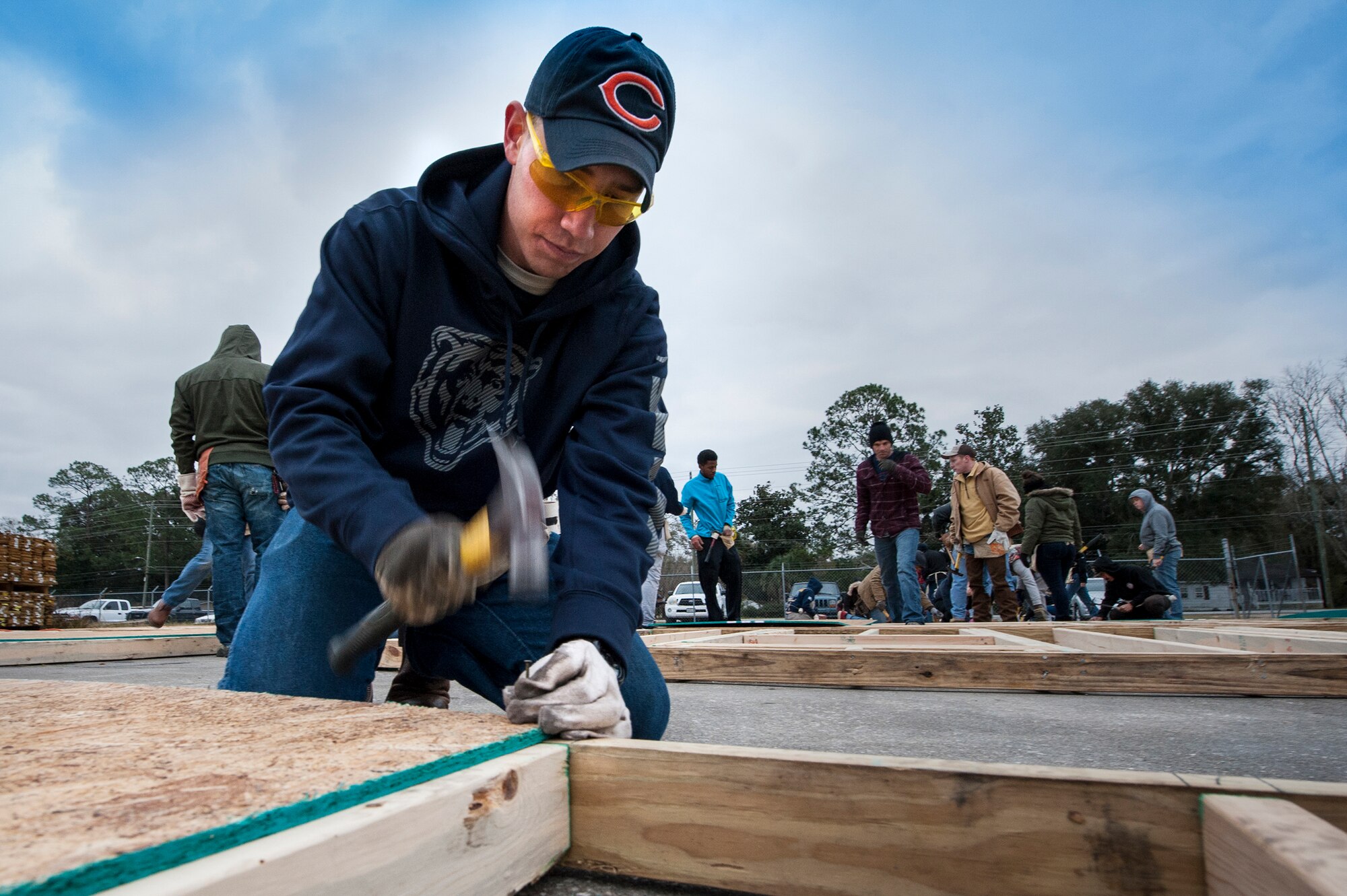 U.S. Air Force Airman 1st Class James Sprunk, 74th Aircraft Maintenance Unit crew chief, hammers a nail during a Habitat for Humanity volunteer event, Jan. 23, 2016, in Valdosta, Ga. Airmen from Moody Air Force Base strengthened ties in the community by building houses for families in need. (U.S. Air Force photo by Airman 1st Class Lauren M. Johnson/Released)