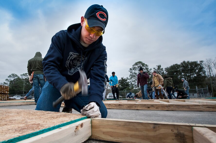  Airman 1st Class James Sprunk, 74th Aircraft Maintenance Unit crew chief, hammers a nail during a Habitat for Humanity volunteer event, Jan. 23, 2016, in Valdosta, Ga. Airmen from Moody Air Force Base strengthened ties in the community by building houses for families in need. (U.S. Air Force photo by Airman 1st Class Lauren M. Johnson/Released) 