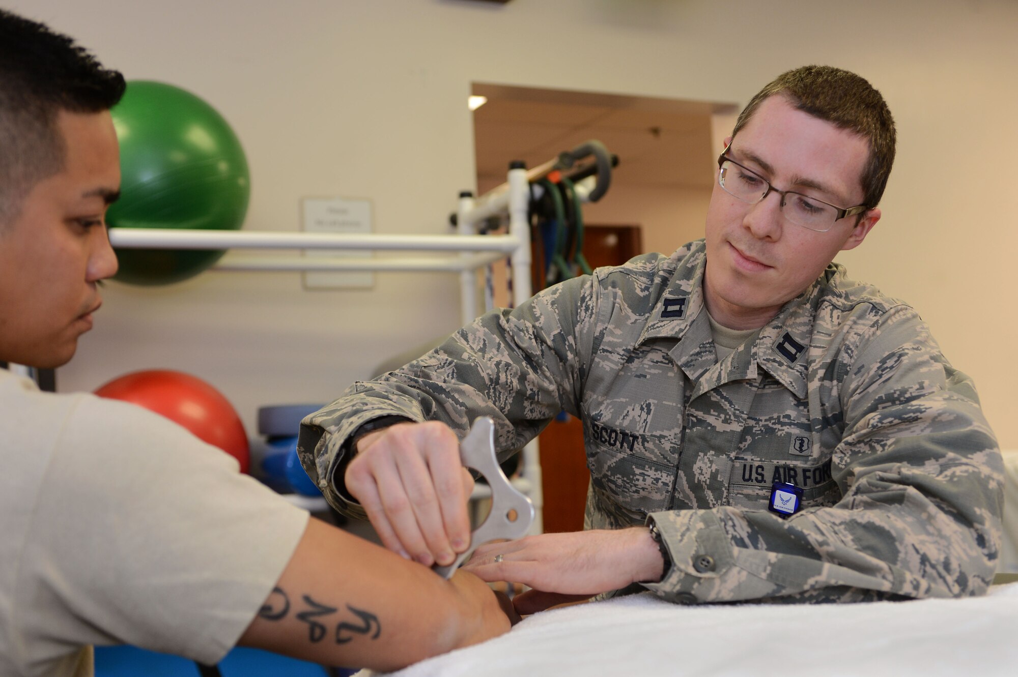 U.S. Air Force Capt. Ryan Scott, 20th Medical Operations Squadron physical therapist, conducts instrument-assisted soft tissue mobilization on a patient at Shaw Air Force Base, S.C., Jan. 21, 2016. Instrument-assisted soft tissue mobilization uses special tools to manually increase blood flow, break down dysfunctional tissue and promote healing in injured soft tissues including muscles and tendons. (U.S. Air Force photo by Senior Airman Zade Vadnais)