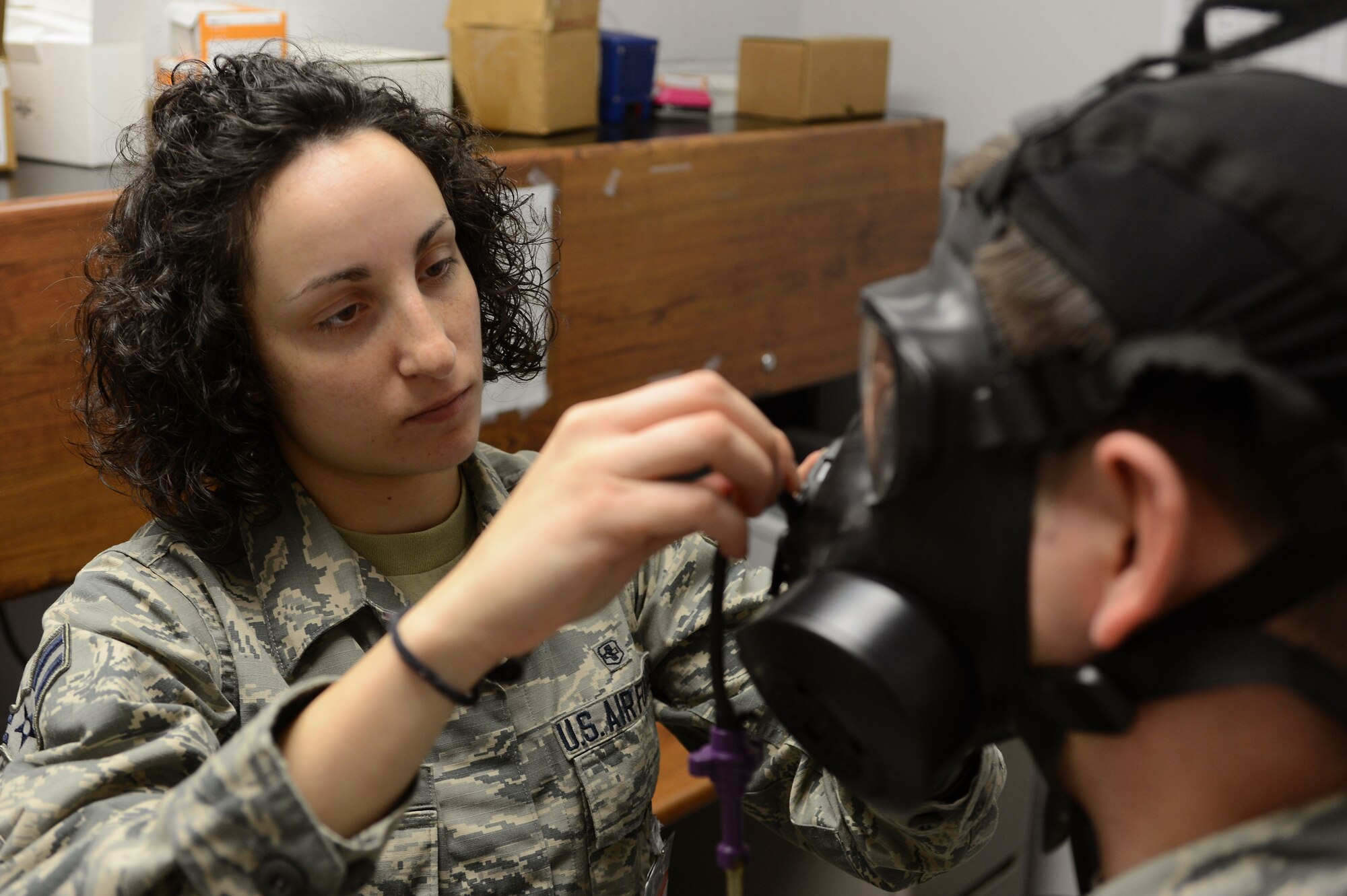 U.S. Air Force Airman 1st Class Carola Anselmi, 20th Aerospace Medicine Squadron bioenvironmental journeyman, conducts a gas mask fit test at Shaw Air Force Base, S.C., Jan. 21, 2016. Airmen from the 20th AMDS bioenvironmental flight conduct gas mask fit tests to ensure all gas masks issued to Team Shaw personnel fit properly and are in good working order. (U.S. Air Force photo by Senior Airman Zade Vadnais)