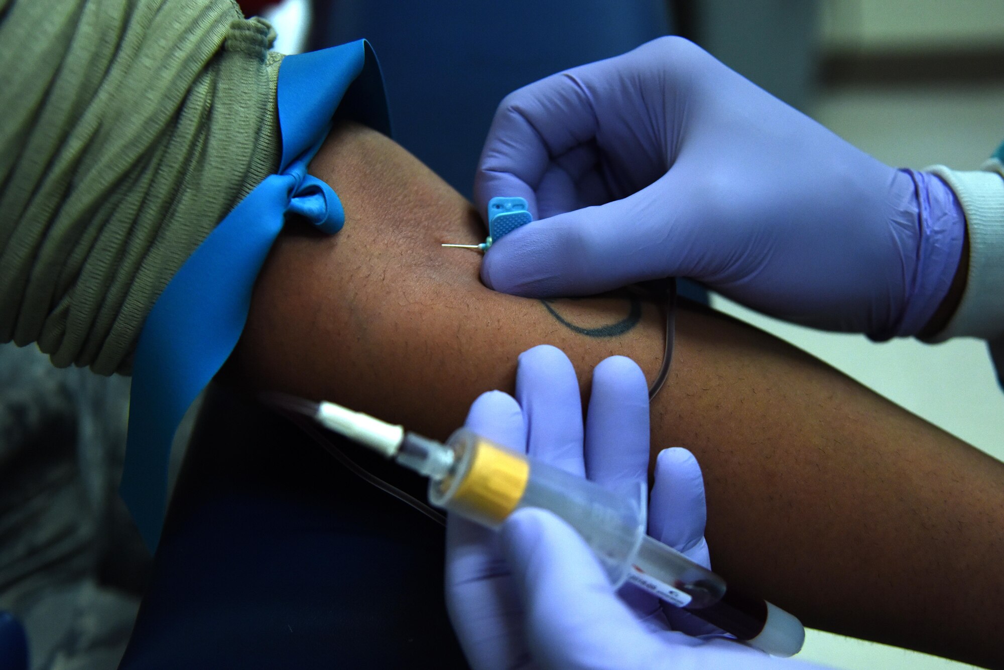 Staff. Sgt. Johnmarth Perez, 4th Medical Support Squadron medical laboratory technician, draws a sample of blood from a patient Jan. 21, 2016, at Seymour Johnson Air Force Base, North Carolina. Samples are collected and analyzed for many types of viruses. Lab technicians work with the bioenvironmental shop to perform presumptive testing for natural and non-natural emergencies such as anthrax, influenza and ebola outbreaks. (U.S. Air Force photo/Staff Sgt. Chuck Broadway)