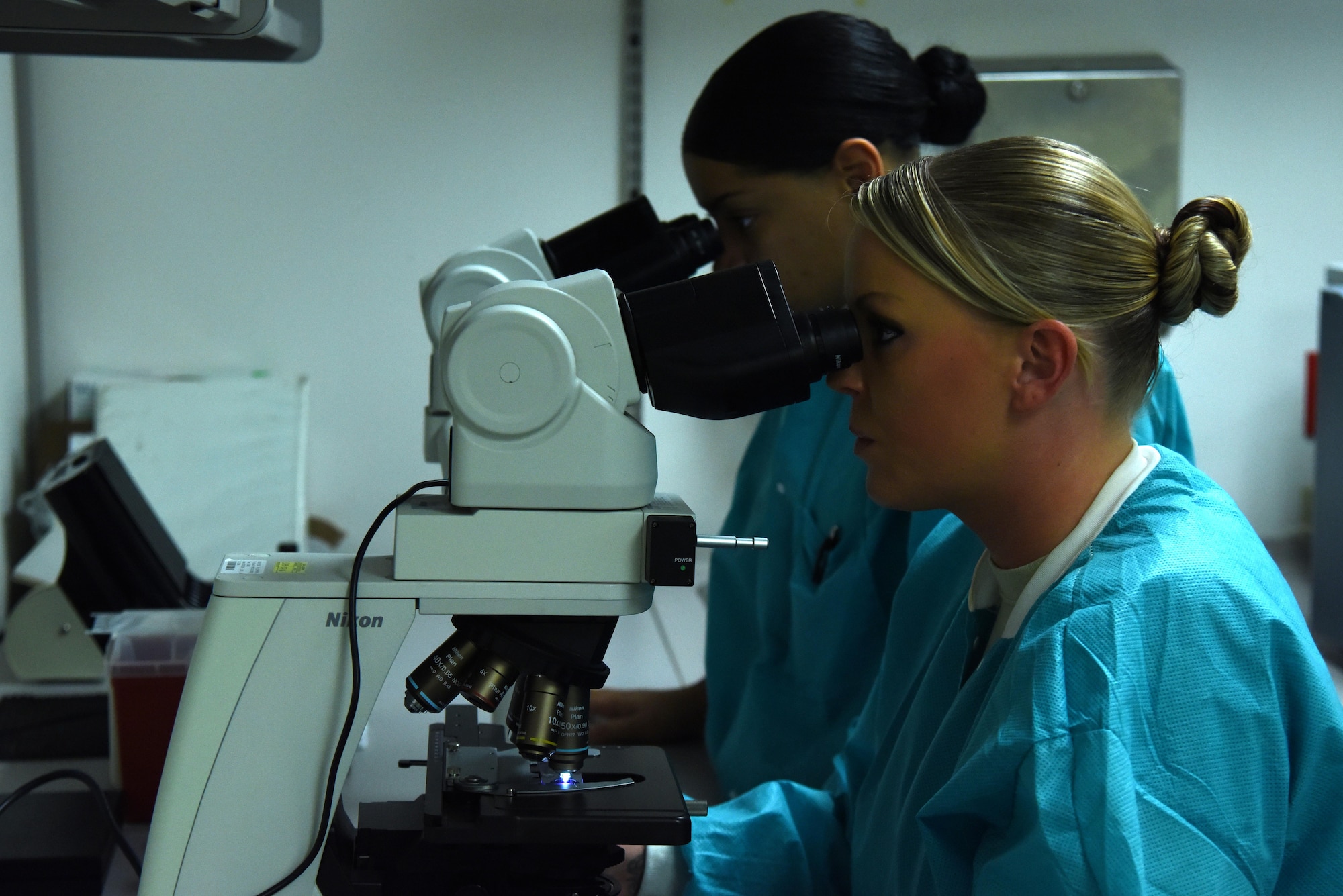 Staff Sgt. Jessica Di Stefano (front), and Senior Airman Kiersten Zardee, both 4th Medical Support Squadron medical laboratory technicians, analyze a blood sample Jan. 21, 2016, at Seymour Johnson Air Force Base, North Carolina. The seven Airmen and two civilian specialists at the lab conduct more than 3,000 different types of tests on fluid samples from patients. Technicians diagnose influenza, perform pregnancy tests as well as work jointly with 4th Security Forces Squadron, Air Force Office of Special Investigations and Drug Demand Reduction personnel to aid on-going investigations. (U.S. Air Force photo/Staff Sgt. Chuck Broadway)