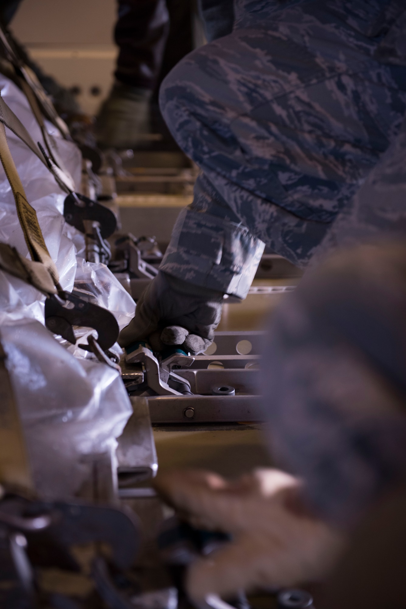 Airmen from the 366th Logistics Readiness Squadron secure latches on cargo in a KC-10 Extender from Travis Air Force Base, California, Jan. 23, 2016 at Mountain Home AFB, Idaho. The cargo will be delivered to Tyndall AFB, Florida, for Combat Archer and Combat Hammer. The exercise is designed to test each participating units’ Weapon System Evaluation Program, determine reliability, evaluate capability and limitations, identify deficiencies, recommend corrective action and maintain combat readiness. (U.S. Air Force photo by Senior Airman Lauren-Taylor Levin/RELEASED)