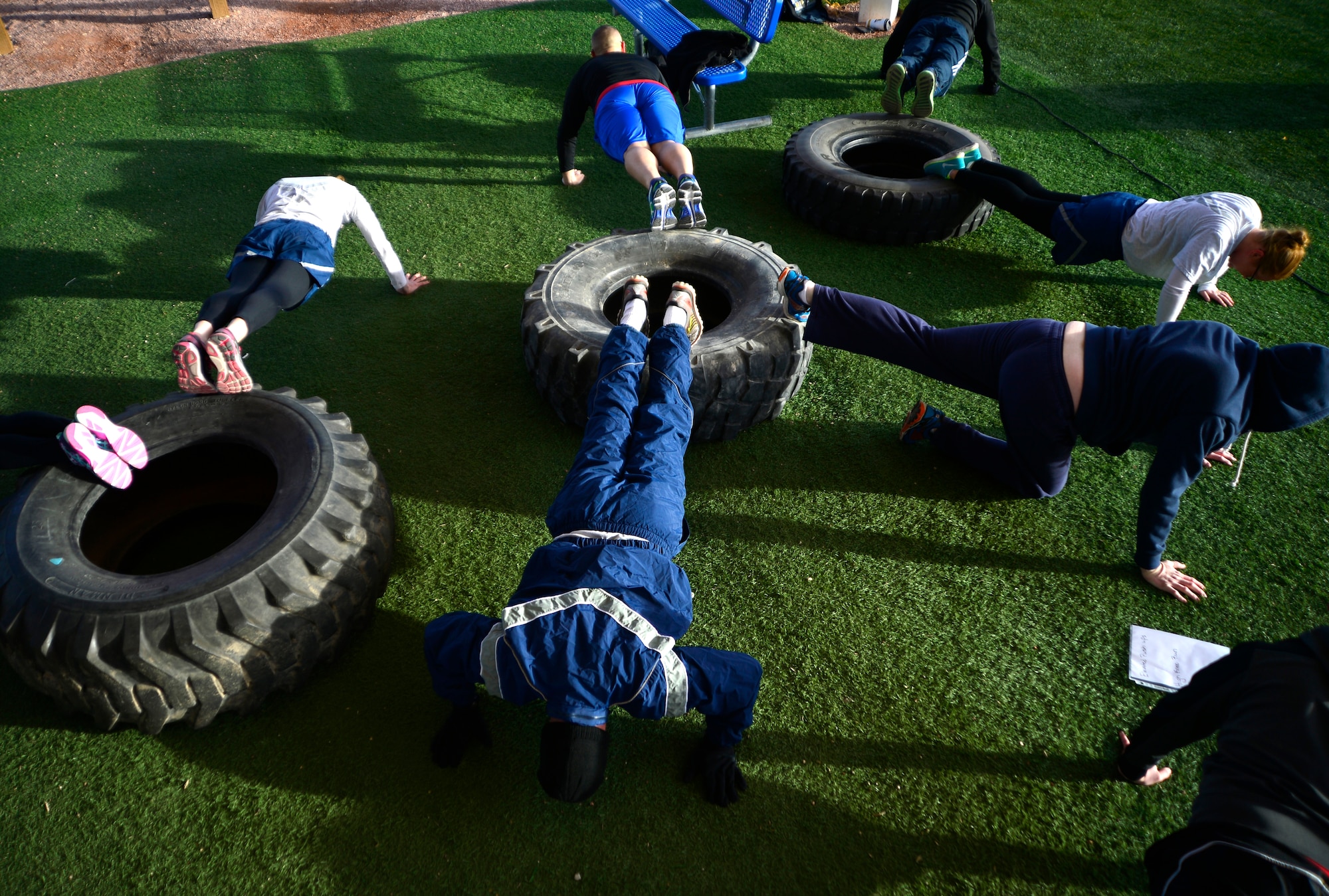 Airmen perform elevated pushups during the Warrior Trained Fitness event Jan. 25, 2016, at Creech Air Force Base, Nevada. The event was part of the Life of a Warrior campaign which aims to help keep Airmen combat-ready by enhancing their spiritual, mental, social, and physical resiliency. (U.S. Air Force photo by Senior Airman Christian Clausen/Released)