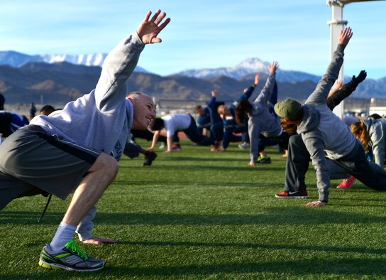 Airmen stretch before the Warrior Trained Fitness event Jan. 25, 2016, at Creech Air Force Base, Nevada. The event was part of the Life of a Warrior campaign which aims to help keep Airmen combat-ready by enhancing their spiritual, mental, social, and physical resiliency. (U.S. Air Force photo by Senior Airman Christian Clausen/Released)