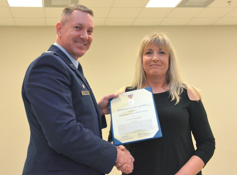 U.S. Air Force Col. Robert K. Lyman, Joint Base Charleston commander, presents the Commander’s Public Service Award to Stacey Lyndbergh, Palmetto Scholars Academy Board of Directors Chairman, in recognition of her outstanding public service and commitment to military families at Joint Base Charleston, South Carolina, since January, 2009. Lyman presented the award during the a ribbon-cutting ceremony celebrating the opening of Palmetto Scholars Academy’s new school building at Hunley Park on Jan. 23, 2016. (U.S. Air Force photo/Airman 1st Class Thomas T. Charlton)