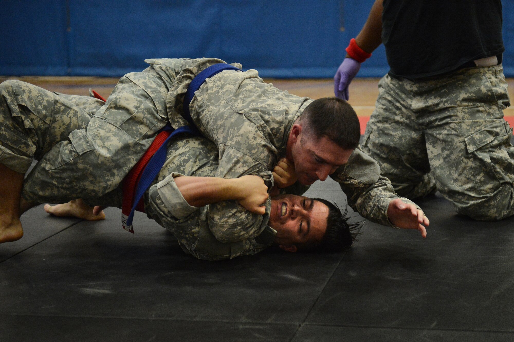 Two U.S. Army 743rd Military Intelligence Battalion Squadron soldiers battle for control during a combatives tournament at the Buckley Fitness Center Jan. 22, 2015, on Buckley Air Force Base, Colo. The army battalion hosts the tournament every year to hone hand-to-hand combat training techniques while engaging in friendly competition. (U.S. Air Force photo by Staff Sgt. Darren Scott/Released)