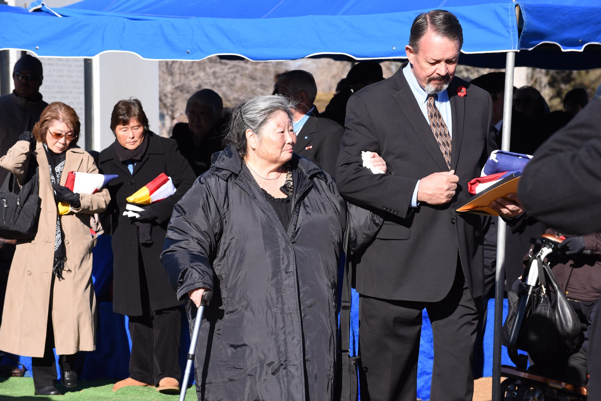 Rick Crandall escorts Leslie, the daughter of Medal of Honor recipient U.S. Army Pvt. George “Joe” Sakato, following Sakato's interment at Fairmount Cemetery in Denver, Jan. 16, 2016. Sakato, Colorado resident and Medal of Honor recipient from World War II, was laid to rest with full military honors. Sakato distinguished himself by extraordinary heroism in action Oct. 29, 1944, on Hill 617 in the vicinity of Biffontaine, France. (U.S. Army National Guard photo by Staff Sgt. Manda Walters/Released)
