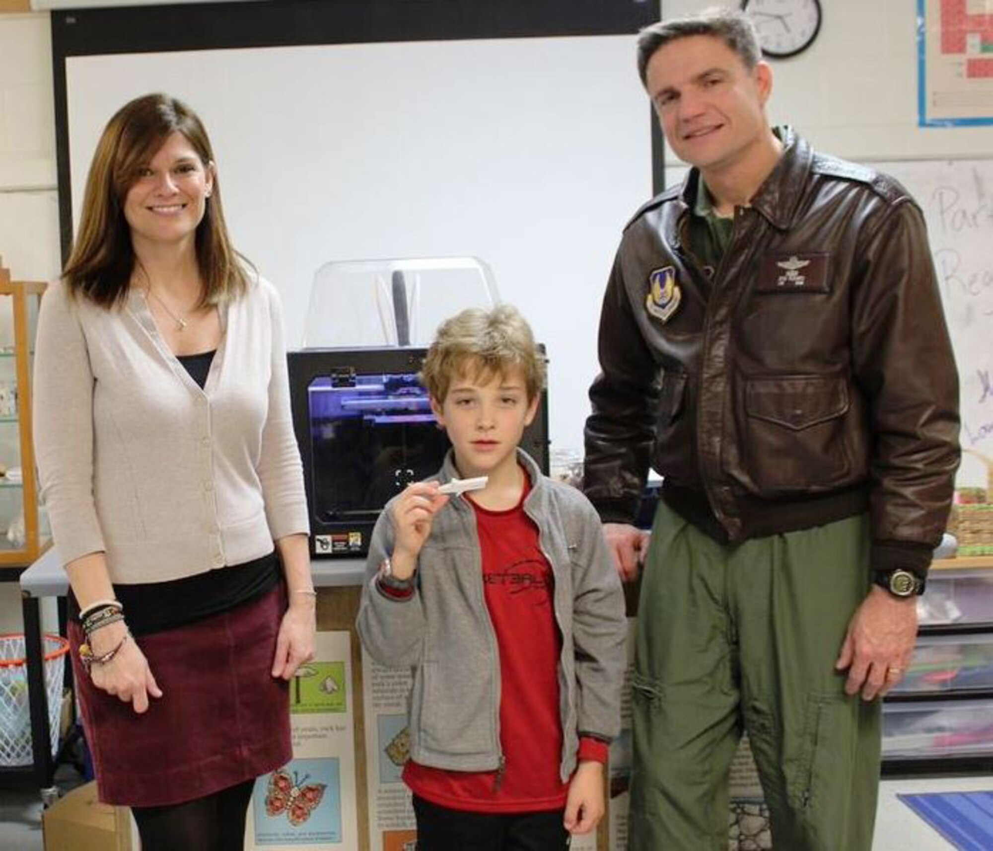 Deb Wimberly (left), science teacher at Westwood Middle School in Manchester, student Eli McLean and AEDC Commander Col. Rodney Todaro check out the 3D printer donated to the AEDC Science, Technology, Engineering and Mathematics Program by Jacobs Technology. Eli holds a shark that was just made using the printer. (U.S. Air Force photo/Jere Matty)