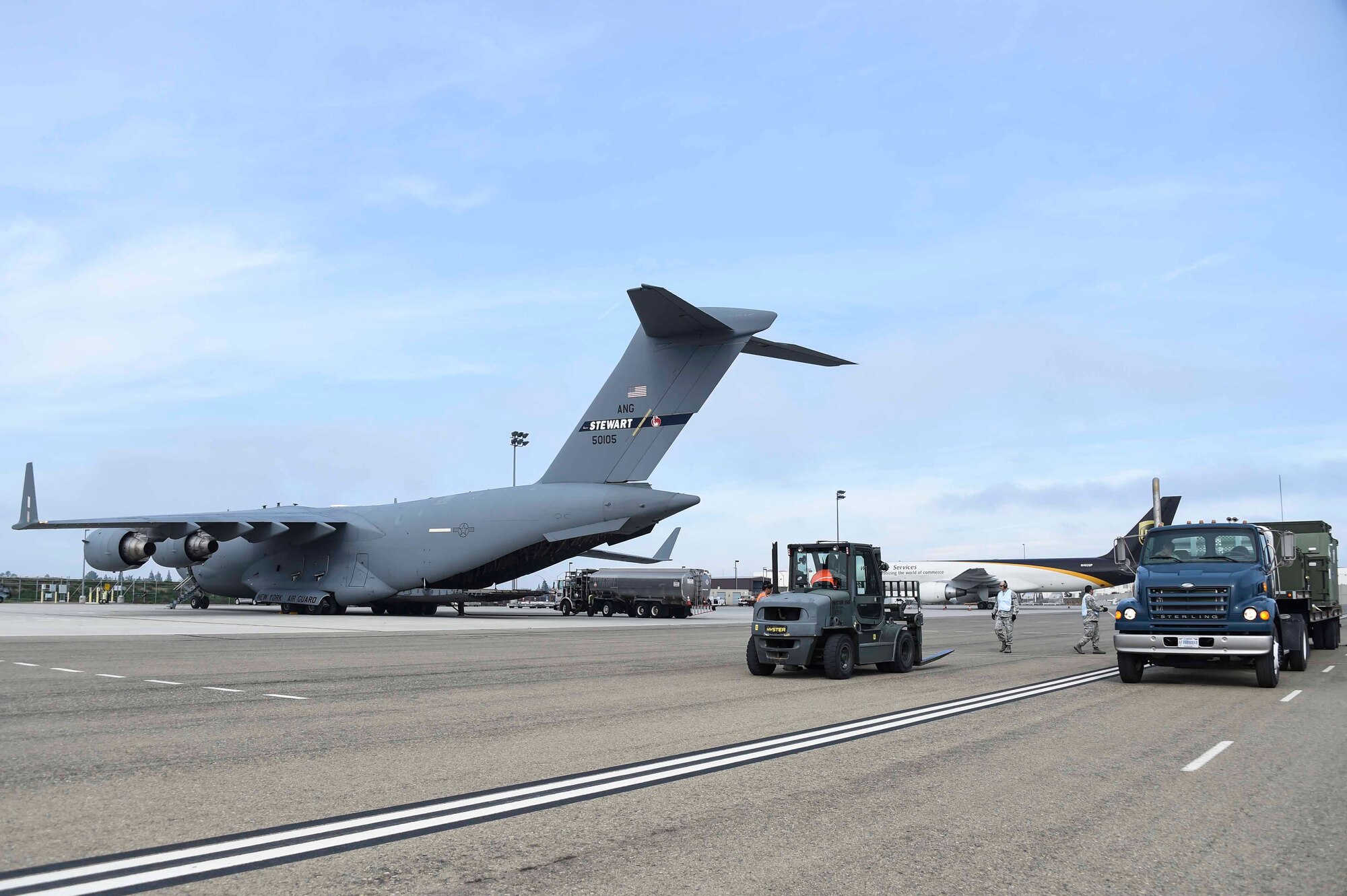 Airmen assigned to the New York Air National Guard’s 105th Airlift Wing and Fresno ANG’s 144th Fighter Wing, prepare to load a C-17 Globemaster III at the Fresno ANG Base, Jan. 21, 2016, in support of the 144th FW's participation in Red Flag 16-01. Red Flag is a realistic combat training exercise, which is hosted by Nellis Air Force Base, Nevada and the U.S. Air Force Warfare Center. The 105th AW airlifted 12 pallets and 29 personnel assigned to the 144th FW. (U.S. Air National Guard Senior Airman Klynne Pearl Serrano)
