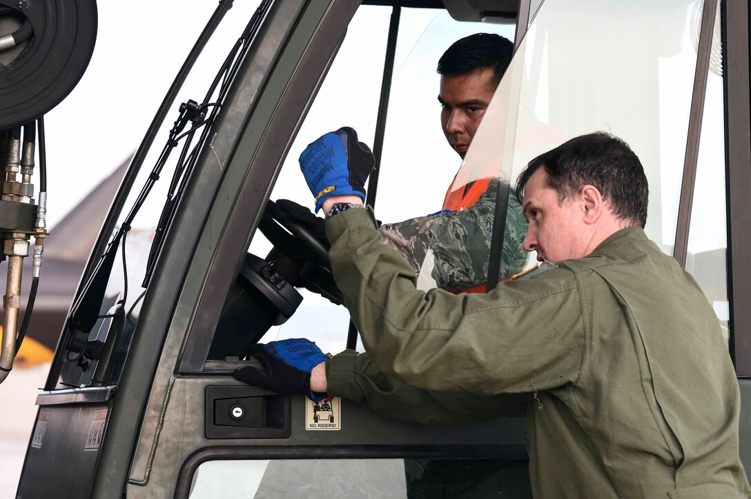 U.S. Air Force Master Sgt. Daryl Martini, a New York Air National Guard 105th Airlift Wing load master, guides Staff Sgt. Christian Chavez-Mejia, 144th Fighter Wing forklift operator, in loading a pallet aboard a C-17 Globemaster III at the Fresno Air National Guard Base, Jan. 21, 2016, in support of the 144th FW’s participation in Red Flag 16-01. Red Flag is a realistic combat training exercise, which is hosted by Nellis Air Force Base, Nevada and the U.S. Air Force Warfare Center. The 105th AW airlifted 12 pallets and 29 personnel assigned to the 144th FW. (U.S. Air National Guard Senior Airman Klynne Pearl Serrano)