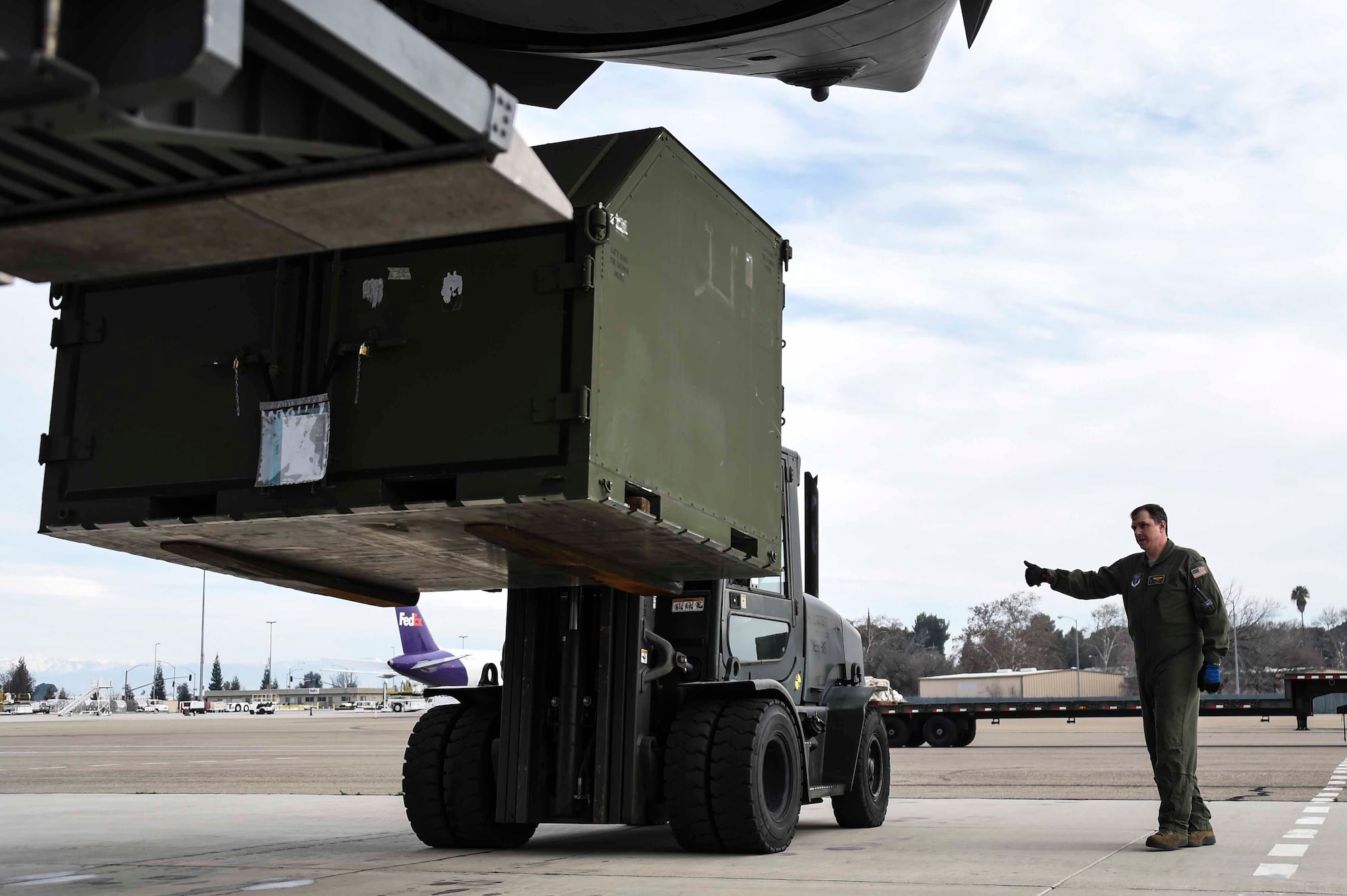 U.S. Air Force Master Sgt. Daryl Martini, a New York Air National Guard 105th Airlift Wing load master, helps load a pallet aboard a C-17 Globemaster III at the Fresno Air National Guard Base, Jan. 21, 2016, in support of the 144th Fighter Wing’s participation in Red Flag 16-01. Red Flag is a realistic combat training exercise, which is hosted by Nellis Air Force Base, Nevada and the U.S. Air Force Warfare Center. The 105th AW airlifted 12 pallets and 29 personnel assigned to the 144th FW. (U.S. Air National Guard Senior Airman Klynne Pearl Serrano)