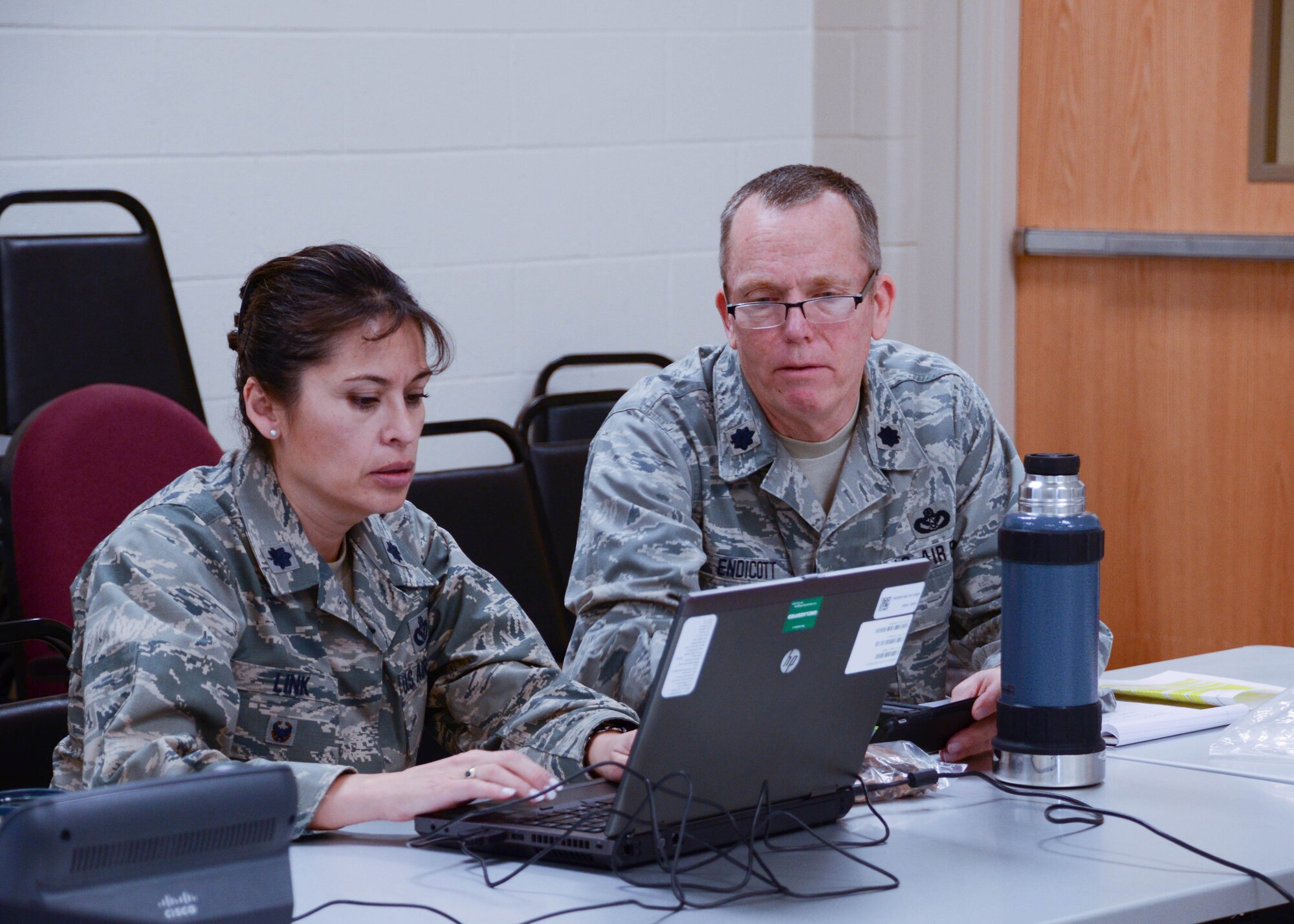 Lt. Col. Grace Link, commander of Task Force Recovery, and Lt. Col. Lane Endicott, 131st Civil Engineer Squadron commander, set up operations at Jefferson Barracks Air National Guard Base, Missouri, Jan. 6, 2016. The task force, led by the Missouri National Guard and supported by the Federal Emergency Management Agency, the U.S. Army Corps of Engineers and other federal and state agencies, is charged with helping individuals, businesses and communities remove debris and recover following historic flooding across the state. (U.S. Air National Guard photo by Staff Sgt. Brittany Cannon)