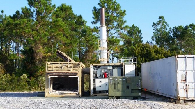 The Air Force Civil Engineer Center recently tested a prototype gasification system at the AFCEC Research and Test Facility on Tyndall Air Force Base, Florida. Engineers are testing the system as an energy efficient and environmentally compliant way to eliminate the use of open pit burning to dispose of municipal solid waste in deployed environments. (U.S. Air Force Photo/Rodney Fisher/Released)
