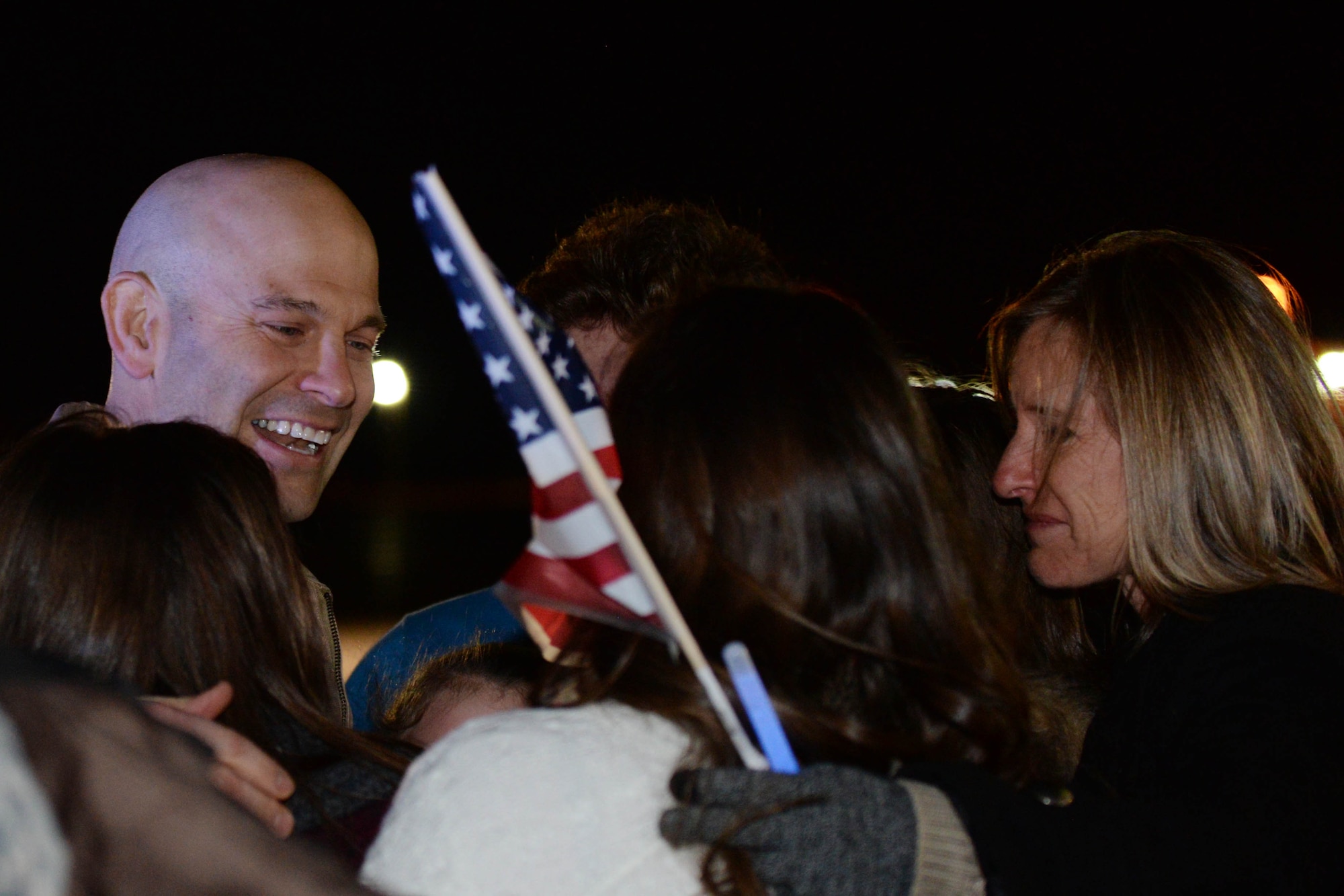 Lt. Col. Joseph, 37th Bomb Squadron commander, left, is greeted by his family upon return from a deployment to Southwest Asia at Ellsworth Air Force Base, S.D., Jan. 24, 2015. Throughout the six months, Ellsworth aircrews conducted B-1 bomber missions designed to rapidly deliver massive quantities of precision and non-precision weapons against adversaries. (U.S. Air Force Photo by Senior Airman Rebecca Imwalle/Released)
