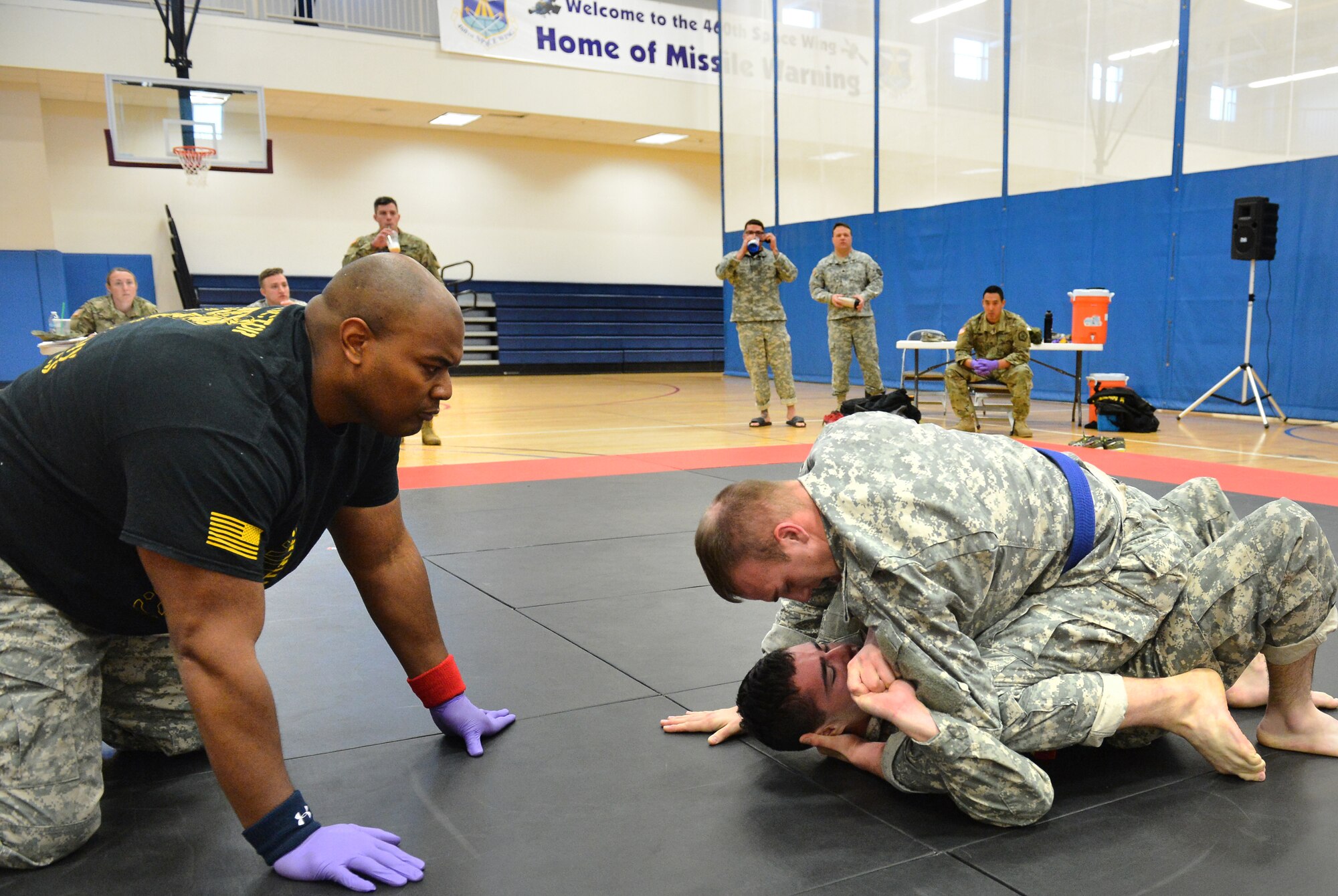 Two U.S. Army 743rd Military Intelligence Battalion Squadron soldiers compete for commander’s cup points during a combatives tournament at the Buckley Fitness Center Jan. 22, 2015, on Buckley Air Force Base, Colo. The army battalion hosts the tournament every year to hone hand-to-hand combat training techniques while engaging in friendly competition. (U.S. Air Force photo by Staff Sgt. Darren Scott/Released)