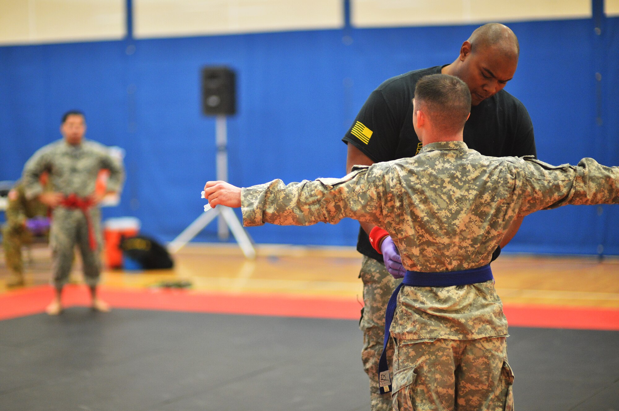 A referee inspects a U.S. Army 743rd Military Intelligence Battalion Squadron soldier before he competes in a combatives tournament at the Buckley Fitness Center Jan. 22, 2015, on Buckley Air Force Base, Colo. The army battalion hosts the tournament every year to hone hand-to-hand combat training techniques while engaging in friendly competition. (U.S. Air Force photo by Staff Sgt. Darren Scott/Released)