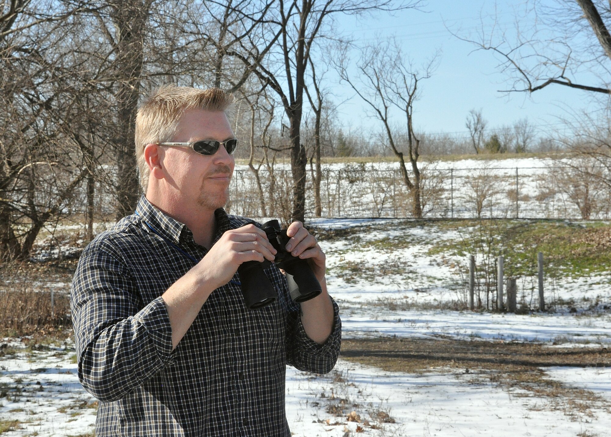 Mark Hohn, 88th Air Base Wing Flight Safety office, searches the woodlands near the Wright-Patterson Air Force Base, Ohio, flightline for signs of increasing numbers of wild life in close proximity to the base’s air field. Preventing wildlife incursions into the air field helps make flight operations safer for aviators using the base.
(U.S. Air Force photo/William Huntington)