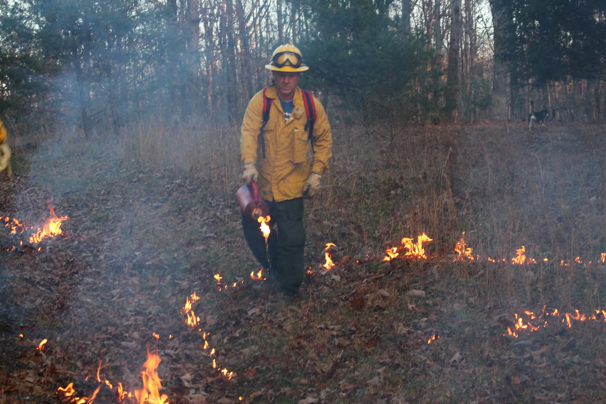 John Lamb, AEDC wildlife biologist, uses a torch to light brush for a training exercise during the basic wildland training course held near the University of the South in Sewanee. The course provides an overview of fuels, weather and topography on fire behavior. (U.S. Air Force photo/Deidre Ortiz)