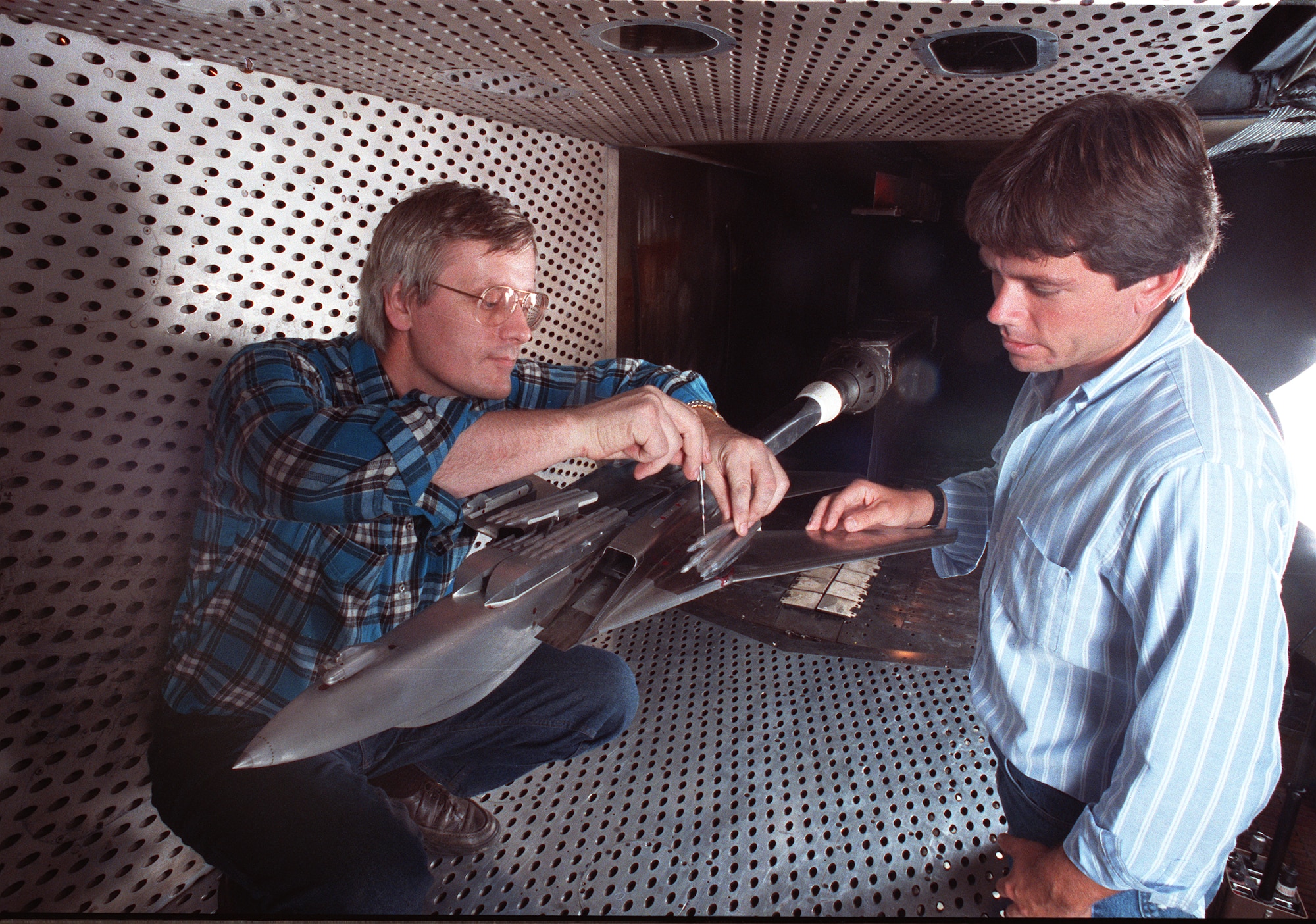An F-14 Tomcat model is readied in 1990 for a store separation test in 4T. (AEDC Photo)