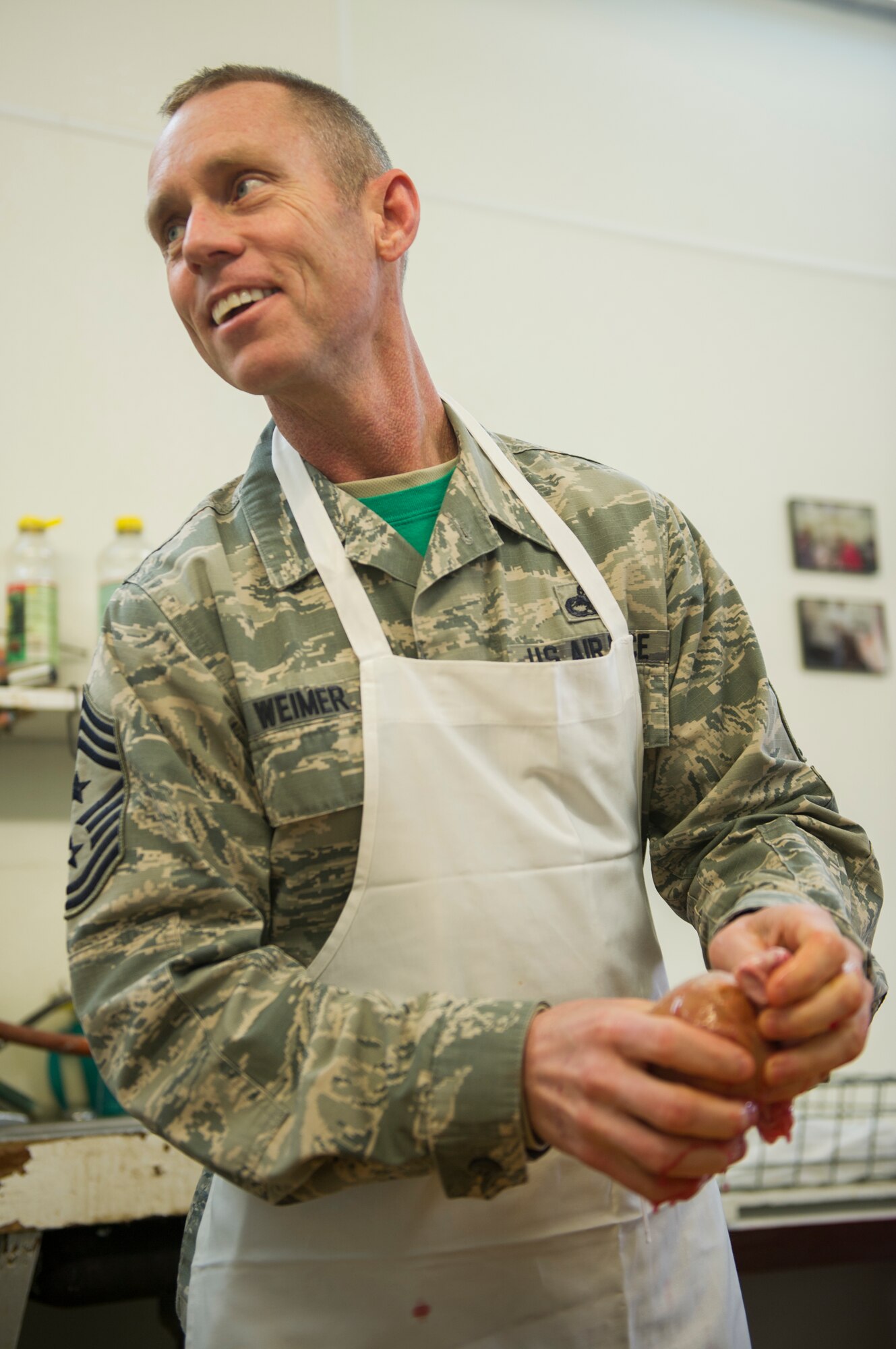 Chief Master Sgt. Geoff Weimer, 5th Bomb Wing command chief, participates in the Sportsmen Feed cut-up event at Bloms’ Locker & Processing in Minot, N.D., Jan. 22, 2015. The cut-up event preceeds the Sportsmen Feed event on base, which features an array of wild game. (U.S. Air Force photo/Senior Airman Apryl Hall)
