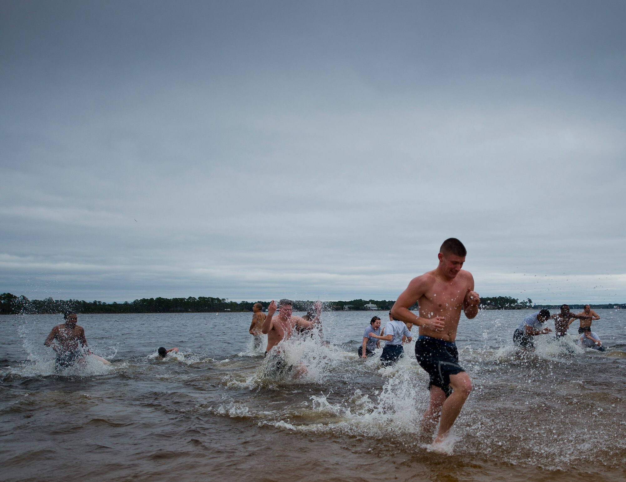 Airmen begin trying to escape the 60-degree waters of Post’l Point during this year’s Polar Bear Plunge Jan. 22 at Eglin Air Force Base, Fla.  Less than a third of the approximately 15 people who waded into the water lasted longer than a minute before running out for blankets and hot chocolate.  (U.S. Air Force photo/Samuel King Jr.)