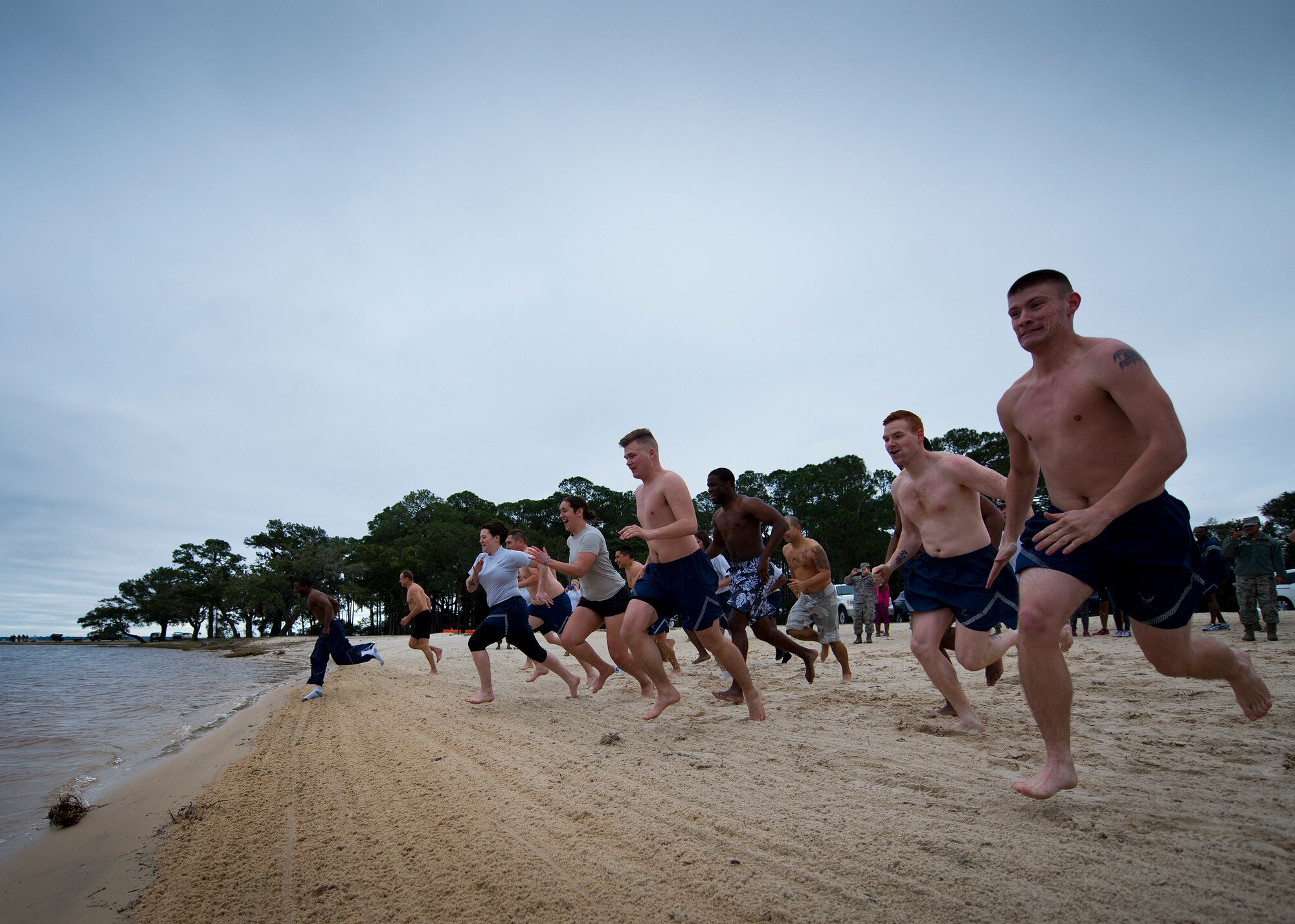 Approximately 15 people braved the windy 46-degree temperatures and took a quick dip in the 60-degree waters of Post’l Point during this year’s Polar Bear Plunge Jan. 22 at Eglin Air Force Base, Fla.  Less than a third of those who waded into the water lasted longer than a minute before running out for blankets and hot chocolate.  (U.S. Air Force photo/Samuel King Jr.)