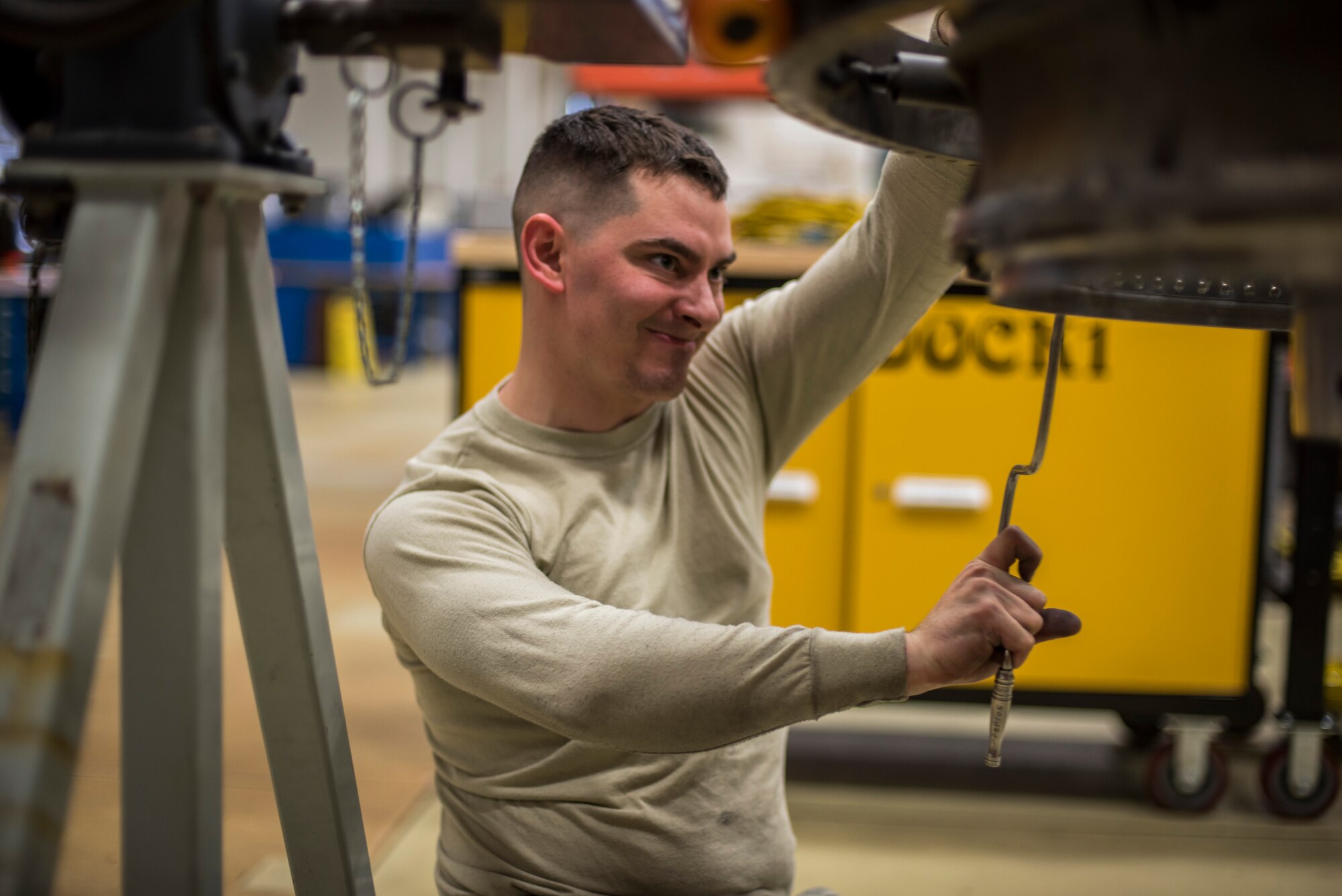 Senior Airman Tyler Susskind, an aerospace propulsion journeyman with the 35th Aircraft Maintenance Squadron, uses a speed handle to tighten a bolt on a turbine frame at Misawa Air Base, Japan, Jan. 25, 2015. The turbine directs airflow out of the combustion chamber as well as provides axial support. (U.S. Air Force photo by Senior Airman Brittany A. Chase)