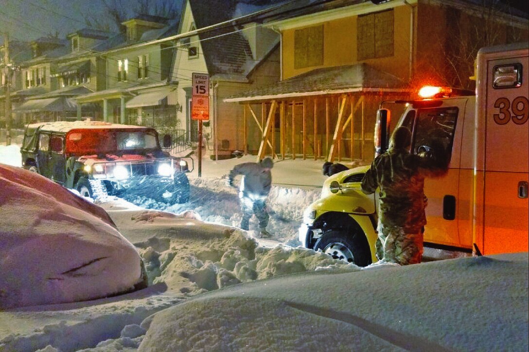 Soldiers work to free an ambulance stuck in the snow while supporting winter storm response operations around Annapolis, Md., Jan. 24, 2016. The soldiers are assigned to the Maryland National Guard's 110th Information Operations Battalion. Photo courtesy of the Maryland National Guard