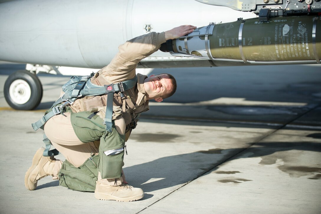 Air Force Maj. Chris Carden performs preflight checks on an F-16 Fighting Falcon aircraft at Bagram Airfield, Afghanistan, before a sortie, Jan. 17, 2016. Carden is a pilot assigned to the 421st Expeditionary Fighter Squadron. U.S. Air Force photo by Capt. Bryan Bouchard