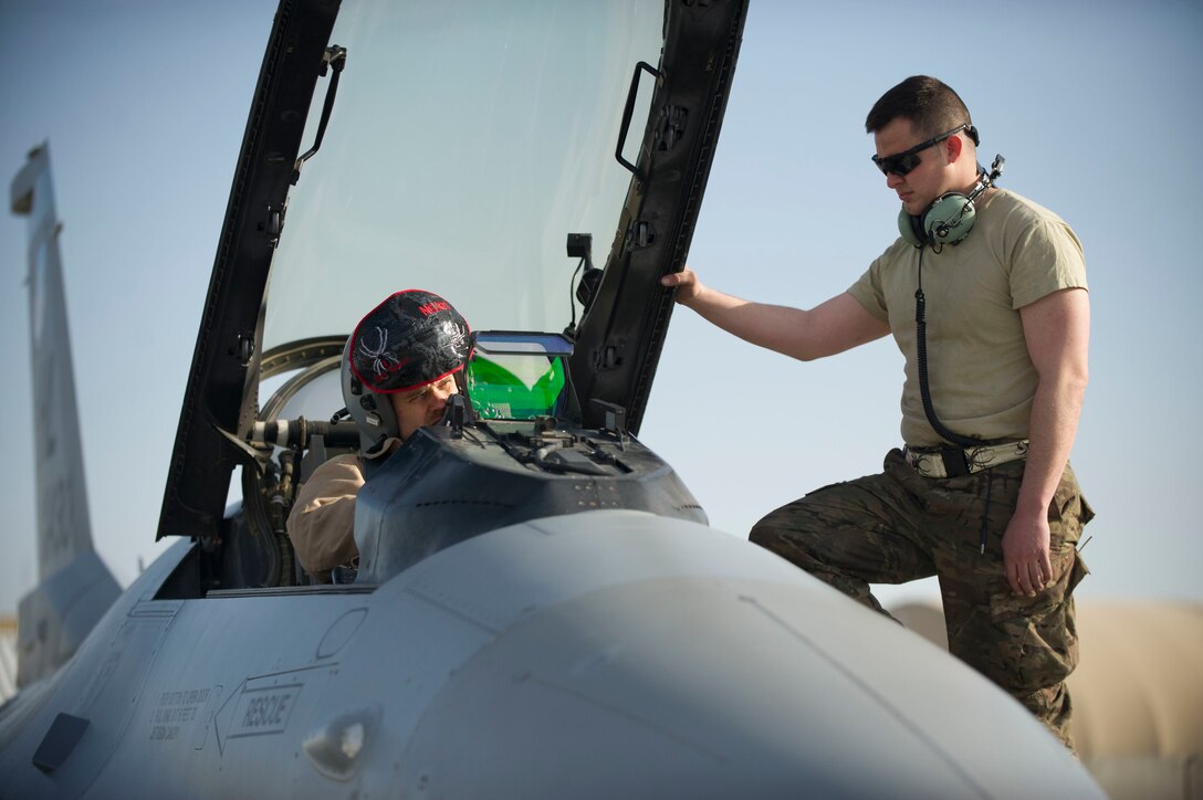Air Force Maj. Chris Carden, left, conducts preflight checks on an F-16 Fighting Falcon aircraft with Staff Sgt. Michael Zimmerman at Bagram Airfield, Afghanistan, before a combat sortie on Jan. 17, 2016. Carden is a pilot assigned to the 421st Expeditionary Fighter Squadron and Zimmerman is a crew chief assigned to the 455th Expeditionary Aircraft Maintenance Squadron. U.S. Air Force photo by Capt. Bryan Bouchard