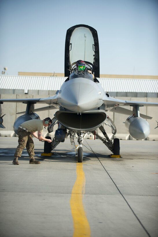 Air Force Maj. Chris Carden, cockpit, and Staff Sgt. Michael Zimmerman conduct preflight checks on an F-16 Fighting Falcon aircraft at Bagram Airfield, Afghanistan, before a combat sortie on Jan. 17, 2016. Carden is a pilot assigned to the 421st Expeditionary Fighter Squadron and Zimmerman is a crew chief assigned to the 455th Expeditionary Aircraft Maintenance Squadron. U.S. Air Force photo by Capt. Bryan Bouchard