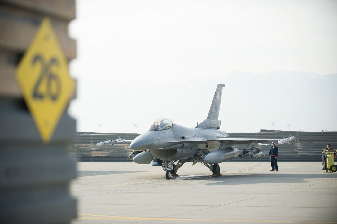 Air Force First Lt. Matthew Sanders finishes his preflight checks on an F-16 Fighting Falcon aircraft at Bagram Airfield, Afghanistan, before a combat sortie on Jan. 17, 2016. Sanders is a pilot assigned to the 421st Expeditionary Fighter Squadron. U.S. Air Force photo by Capt. Bryan Bouchard