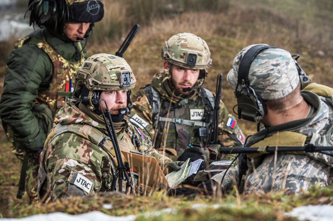 U.S. Air Force Capt. Skylar Jackson, right, debriefs Slovenian and Italian soldiers during exercise Allied Spirit IV on Hohenfels training area, Germany, Jan. 25, 2016. Exercise Allied Spirit IV is a multinational exercise to enhance tactical interoperability and test secure communications between NATO alliance members and partner nations. U.S. Army photo by Sgt. 1st Class Caleb Barrieau


