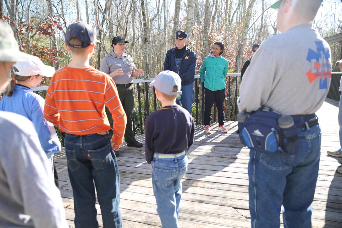 Supervisory Park Ranger Aleutia Scott conducts a safety brief for volunteers from the Marine Forces Reserve’s Chaplain’s Office at Barataria Nature Preserve, part of Jean Lafitte Historical Park and Preserve in Marrero, La., Jan. 16, 2016. The volunteers from MARFORRES spent the day cleaning signs and clearing paths through the hardwood forest areas of the preserve. (U.S. Marine Corps photo by Cpl. Tiffany Edwards)